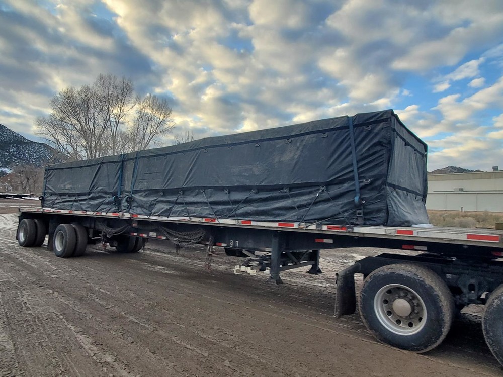 Rubber Tarp Straps Securing Lumber Tarp on Flatbed Trucking Depot