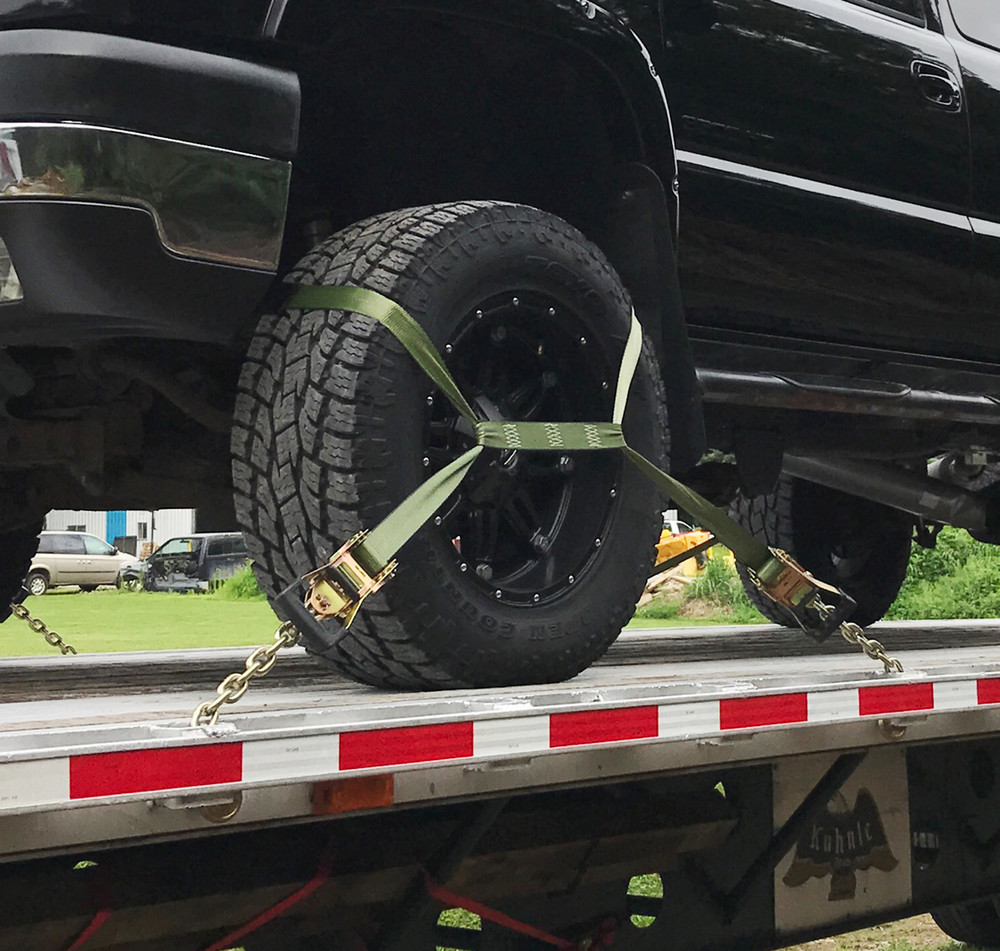Wheel Net Tie Down Strap In Use Securing Pickup Truck  Trucking Depot
