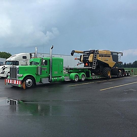 Flatbed Trailer with heavy farm equipment on trailer