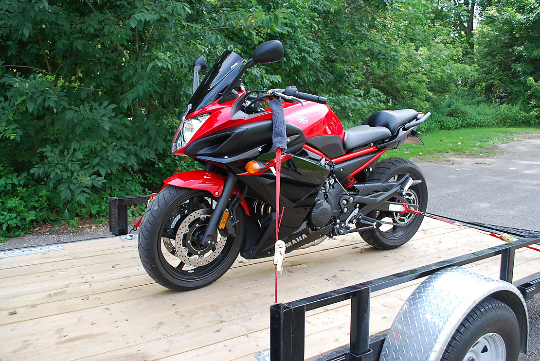 Motorcycle secured to a trailer with a 1 inch ratchet strap with loops