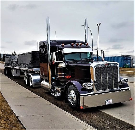 Flatbed semitrailer securing cargo with winch straps and tarp  Ratchet Straps USA