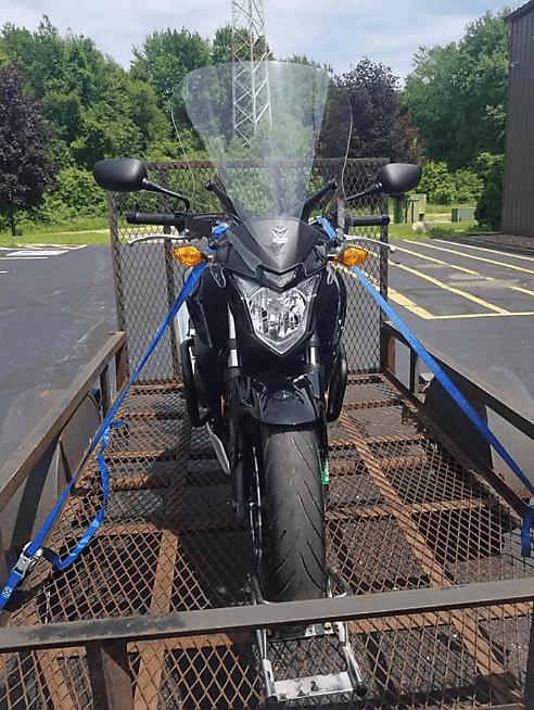 Motorcycle Being Tied Down On A Motorcycle Trailer