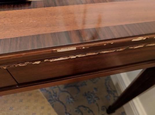 A table that has been damaged during a move from scratches