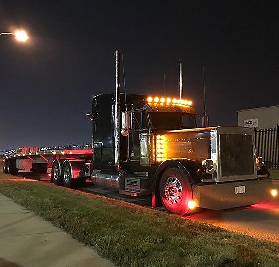 Professional Flatbed Truck Driver Waiting to be loaded on trailer