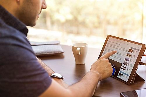 Man using internet and tablet