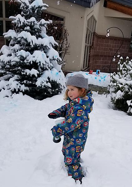 Girl in snow with spray bottle