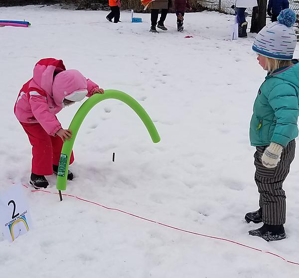 boy and girl play in snow