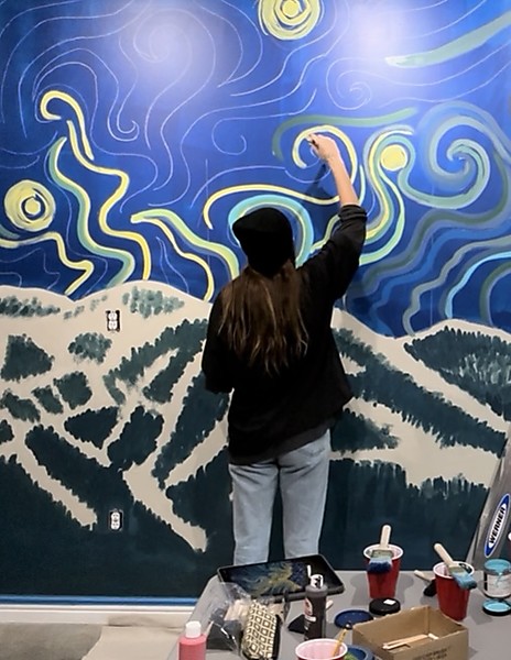 Bri Leslie painting a mural
