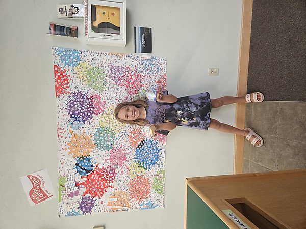 Girl standing in front of Making Place mural